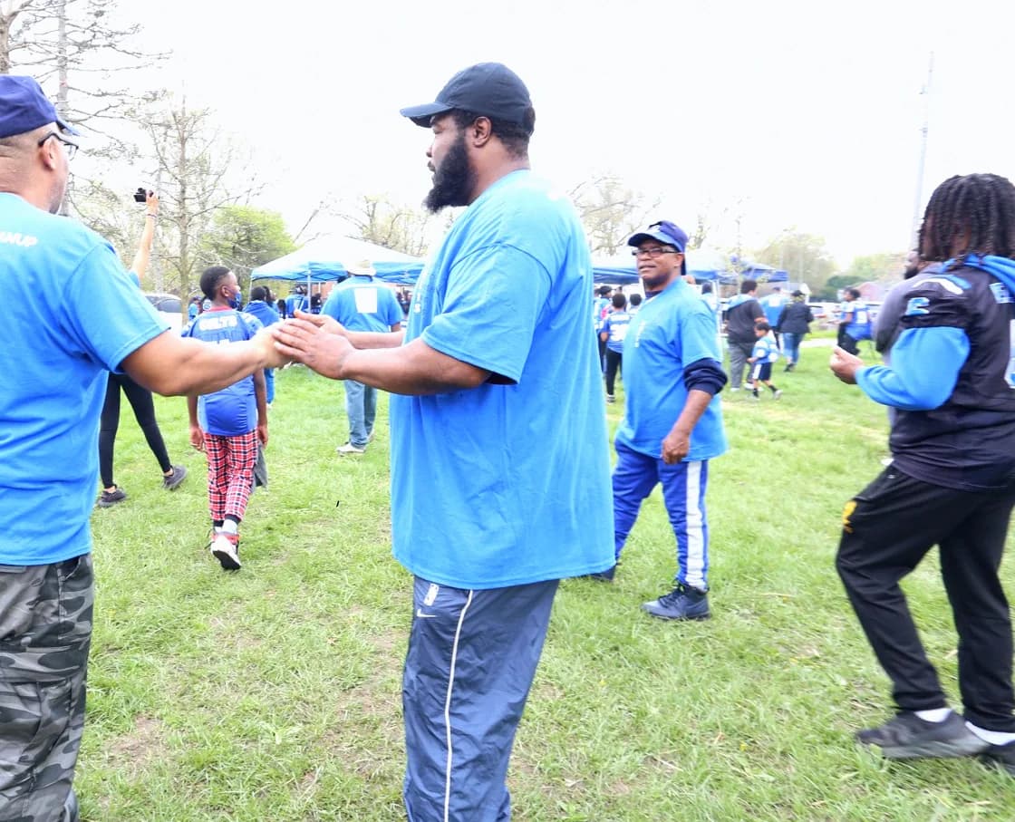 Bobby Christian greeting a volunteer at a neighbourhood cleanup in Detroit